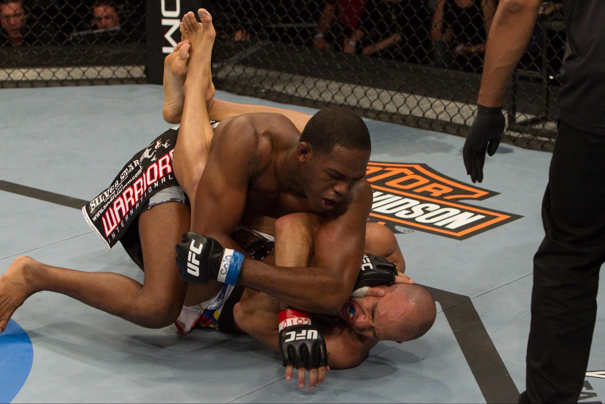 Jon Jones in dominant top position grinding elbow into opponent's face